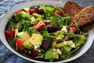 Delicious Greek salad featuring avocado, feta, and olives, ideal for a healthy meal.