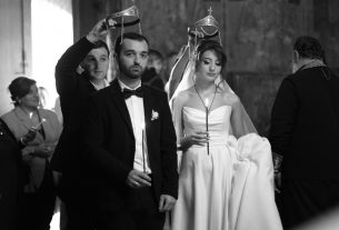 A traditional wedding ceremony with bride and groom, captured in striking black and white.